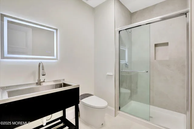 a view of empty room with wooden floor and fireplace