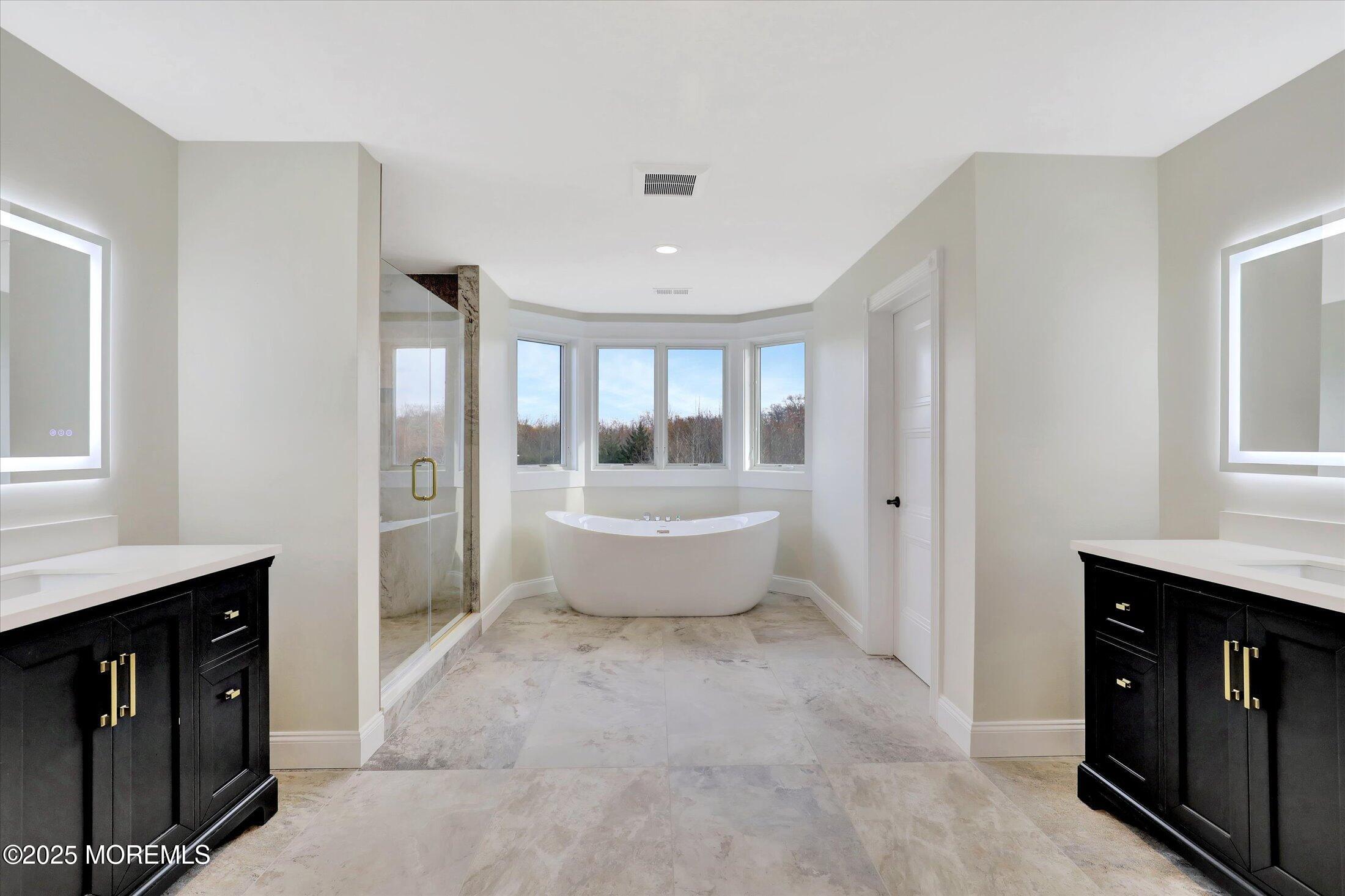 5 Cook Court Millstone Township, NJ 08535 - Photo 36 of 58 a spacious bathroom with a tub sink and mirror