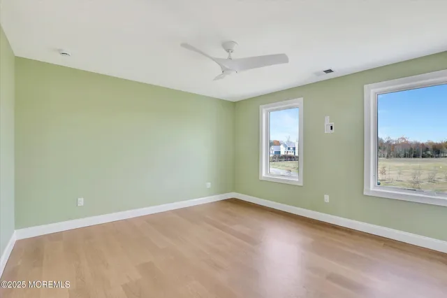 a view of a big yard with an ocean view