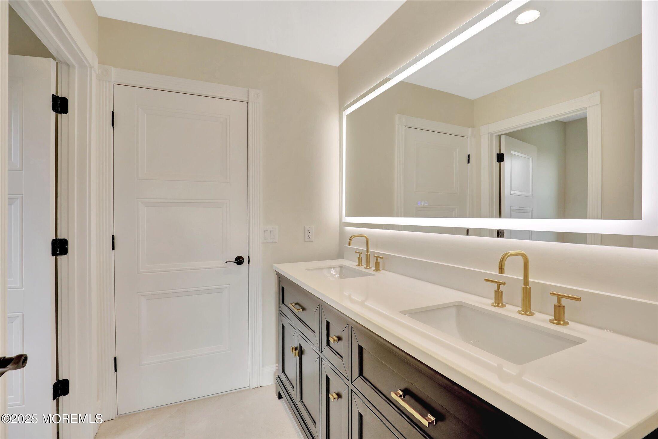 5 Cook Court Millstone Township, NJ 08535 - Photo 41 of 58 a bathroom with a sink and a mirror