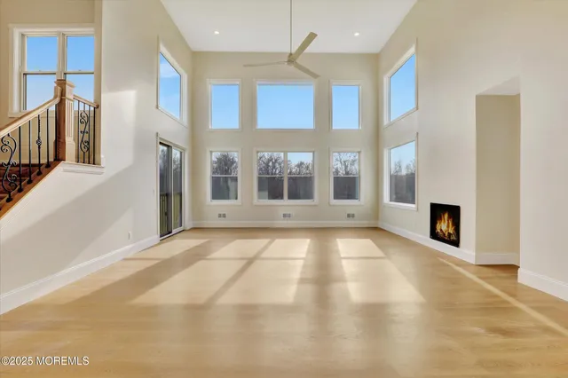 a view of an empty room with window and fireplace