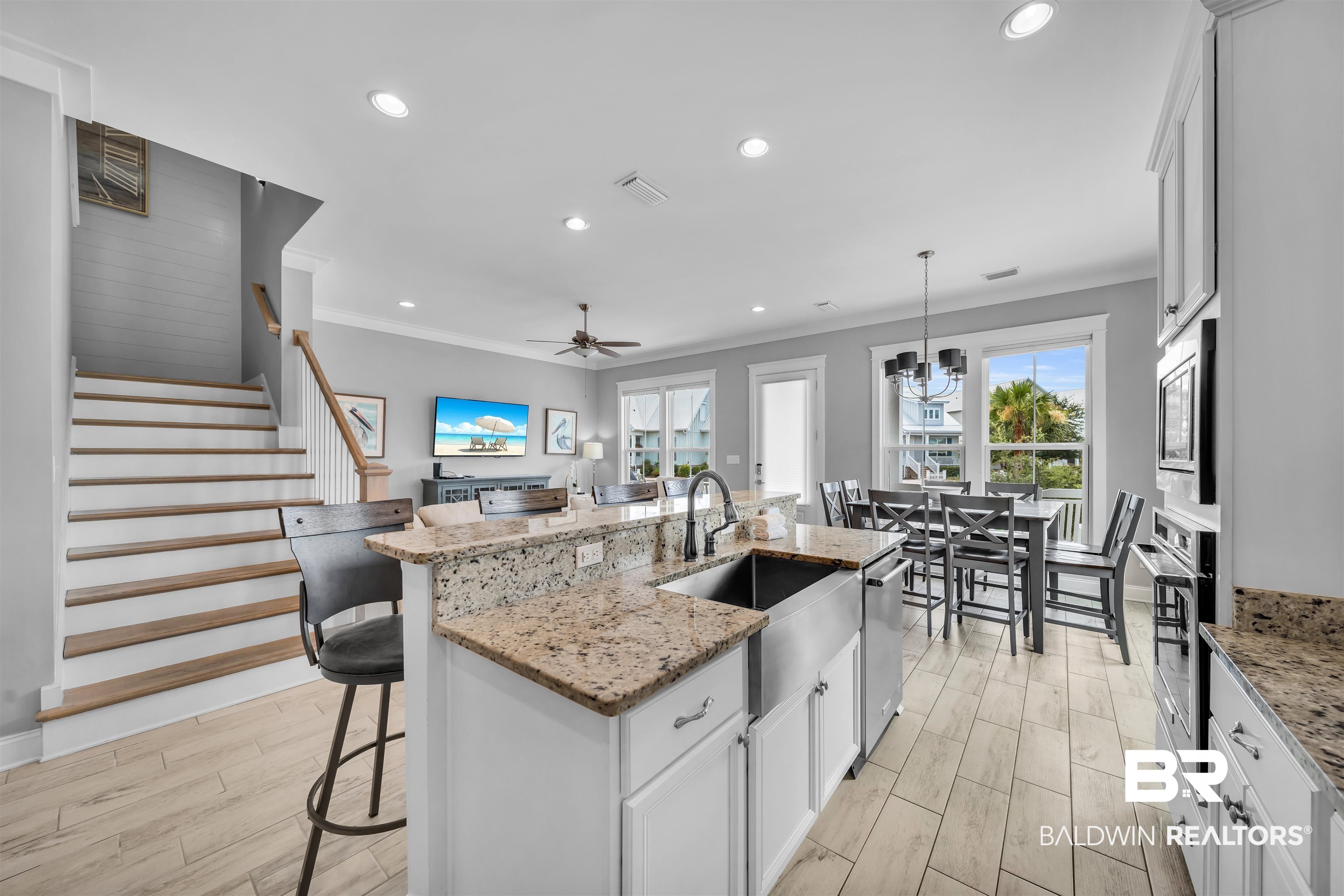 47 Parks Edge Orange Beach, AL 36561 - Photo 7 of 40 Kitchen featuring crown molding, recessed lighting, a kitchen breakfast bar, a ceiling fan, and a center island with sink