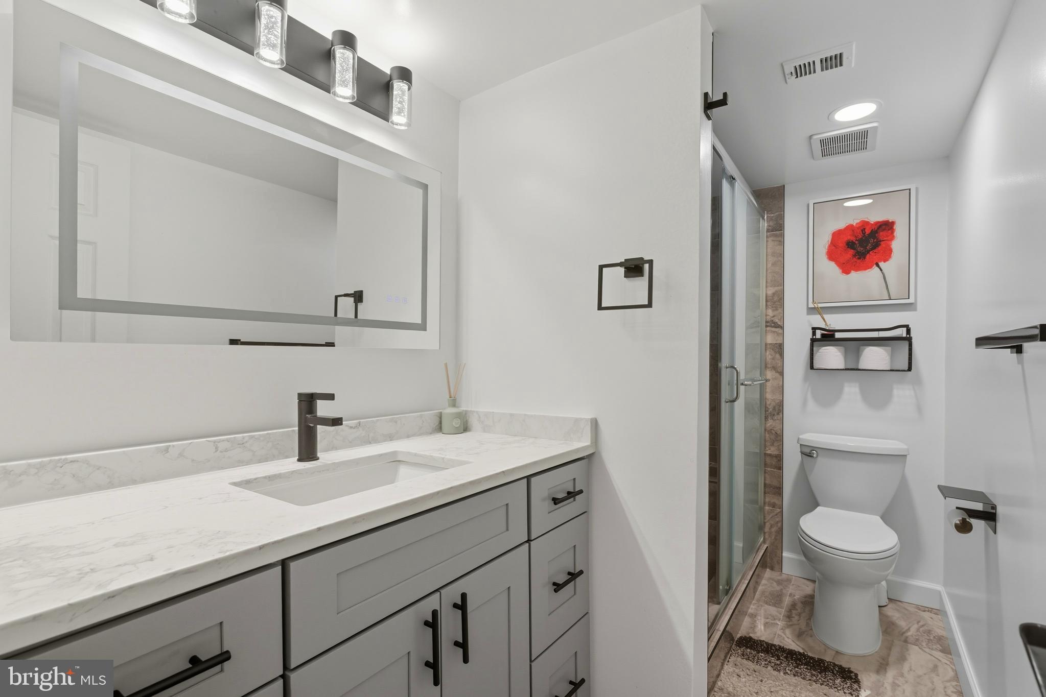11430 Strand Drive, Unit R203 Rockville, MD 20852 - Photo 11 of 31 a bathroom with a sink a toilet and a mirror