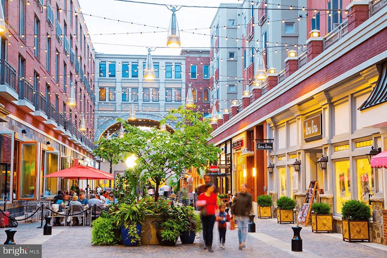 11430 Strand Drive, Unit R203 Rockville, MD 20852 - Photo 30 of 31 a group of people sitting in front of a building