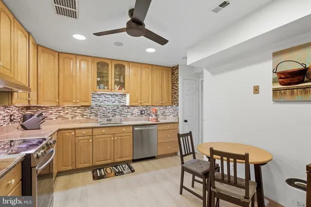 a kitchen with a stove a sink and a refrigerator