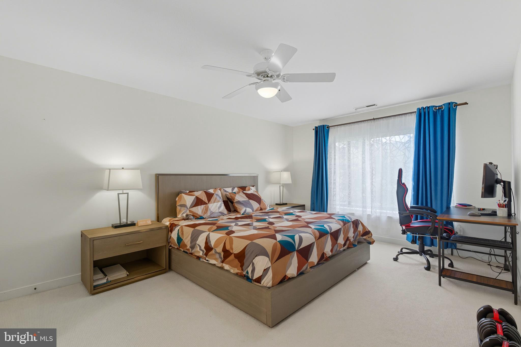 11430 Strand Drive, Unit R203 Rockville, MD 20852 - Photo 8 of 31 a bedroom with a bed and a chandelier