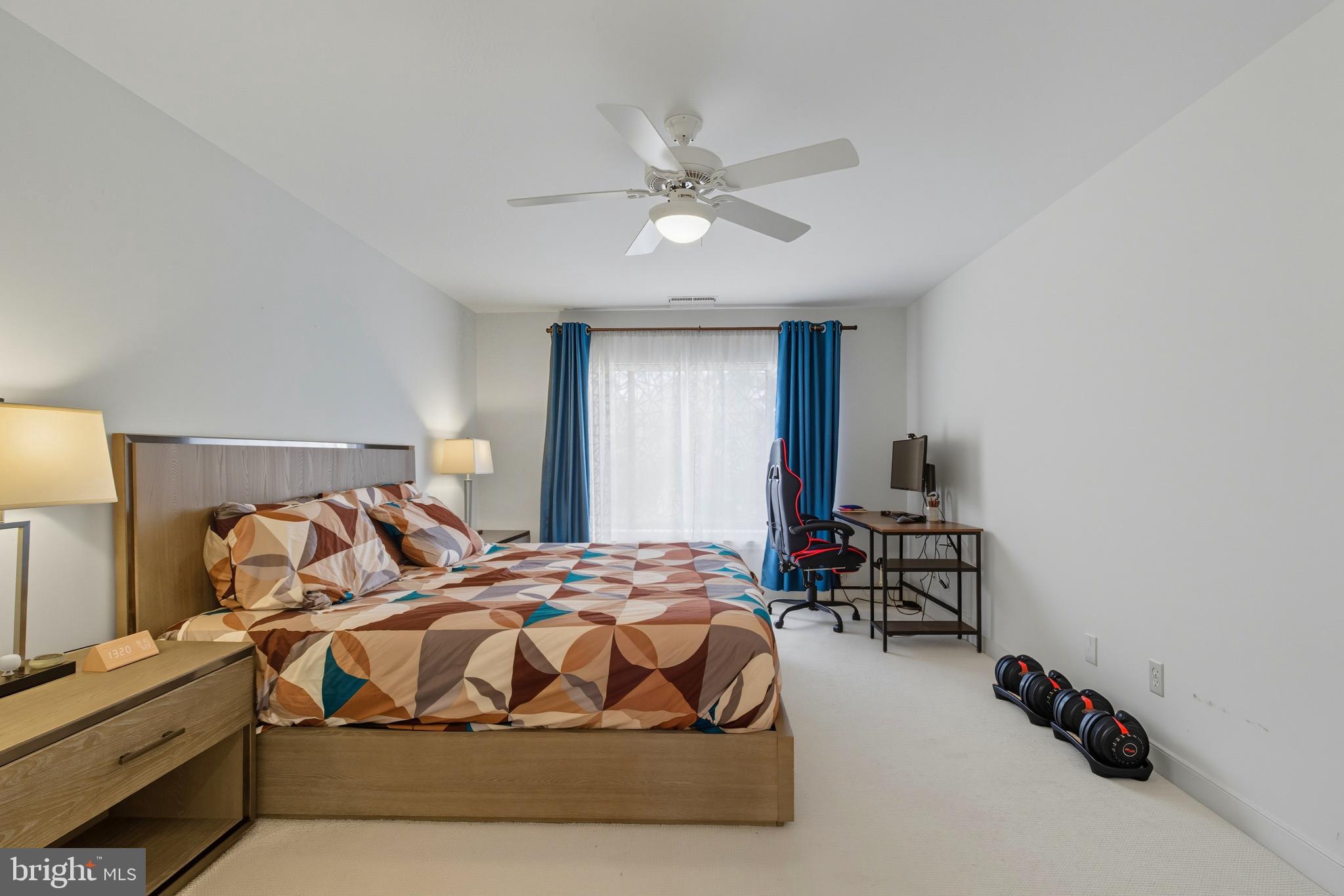 11430 Strand Drive, Unit R203 Rockville, MD 20852 - Photo 9 of 31 a bedroom with a bed and a chandelier