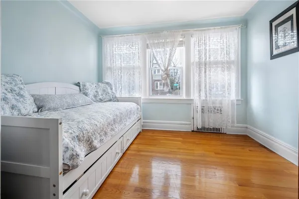 a spacious bedroom with a bed and a window