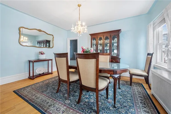a view of a dining room with furniture a rug and wooden floor