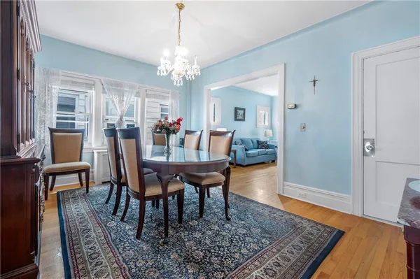 a view of a dining room with furniture and chandelier