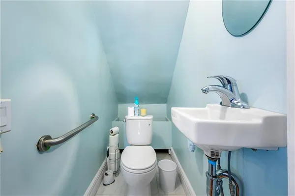 a bathroom with a sink a toilet and a mirror