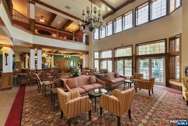a living room with furniture or chandelier and a dining table
