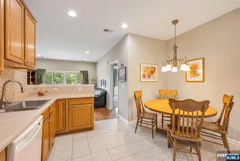 a kitchen with a sink dining table and chairs