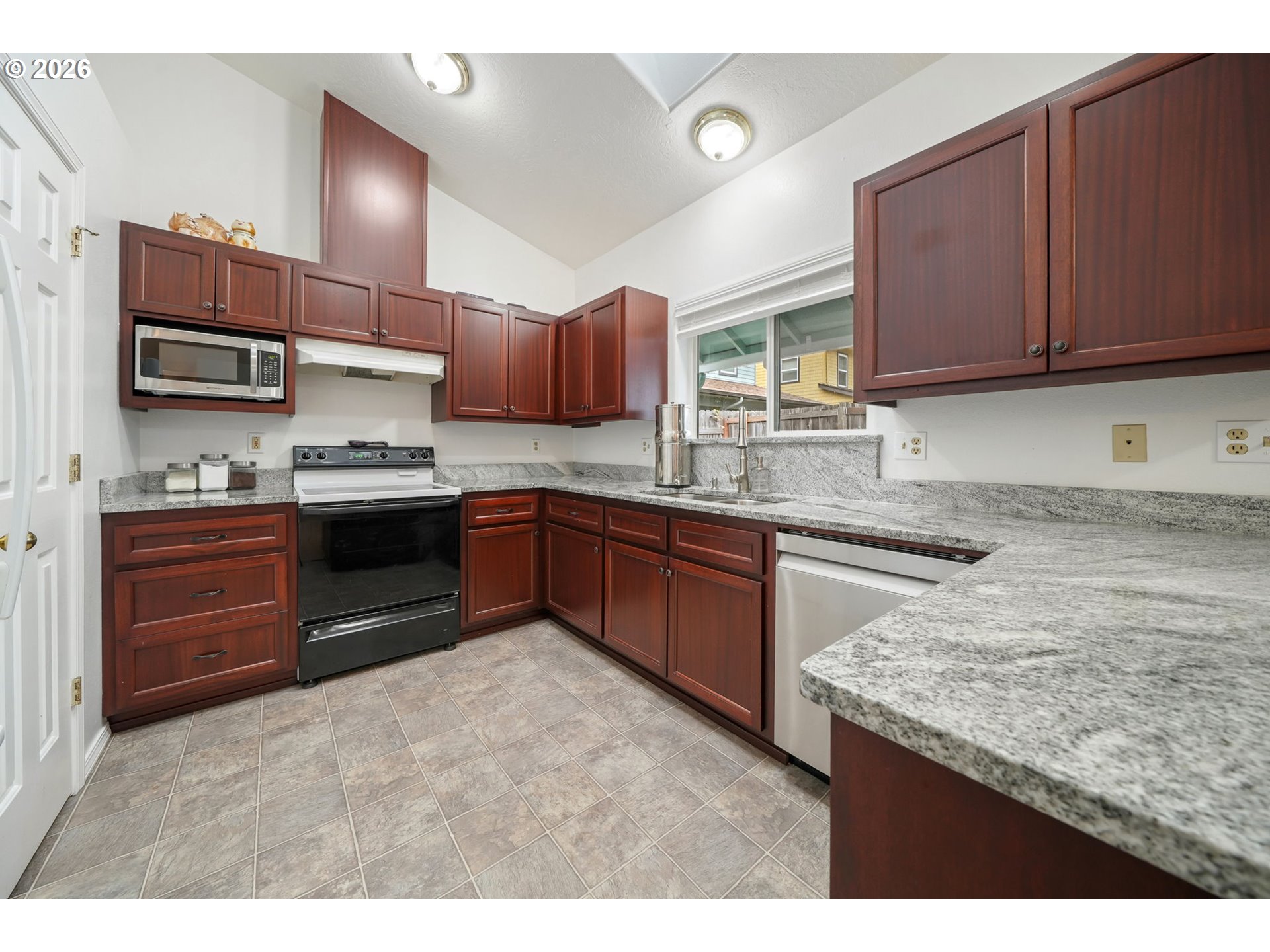 2102 South 8th Street Cottage Grove, OR 97424 - Photo 11 of 28 a kitchen with stainless steel appliances granite countertop wooden cabinets a stove top oven a sink and dishwasher