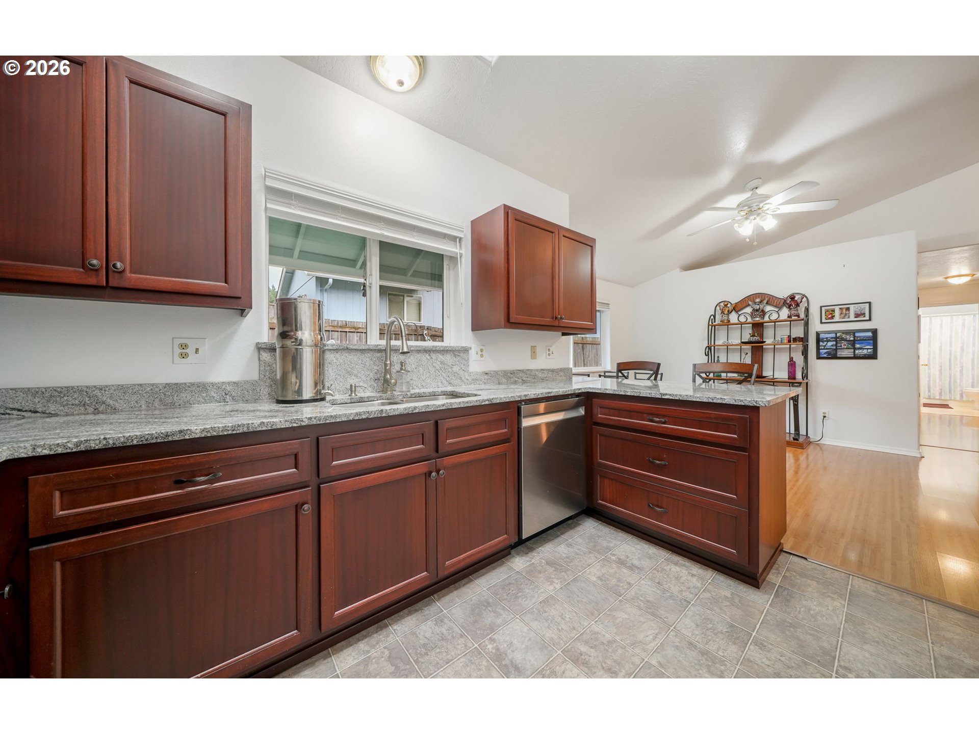 2102 South 8th Street Cottage Grove, OR 97424 - Photo 13 of 28 a kitchen with granite countertop a sink cabinets and stainless steel appliances