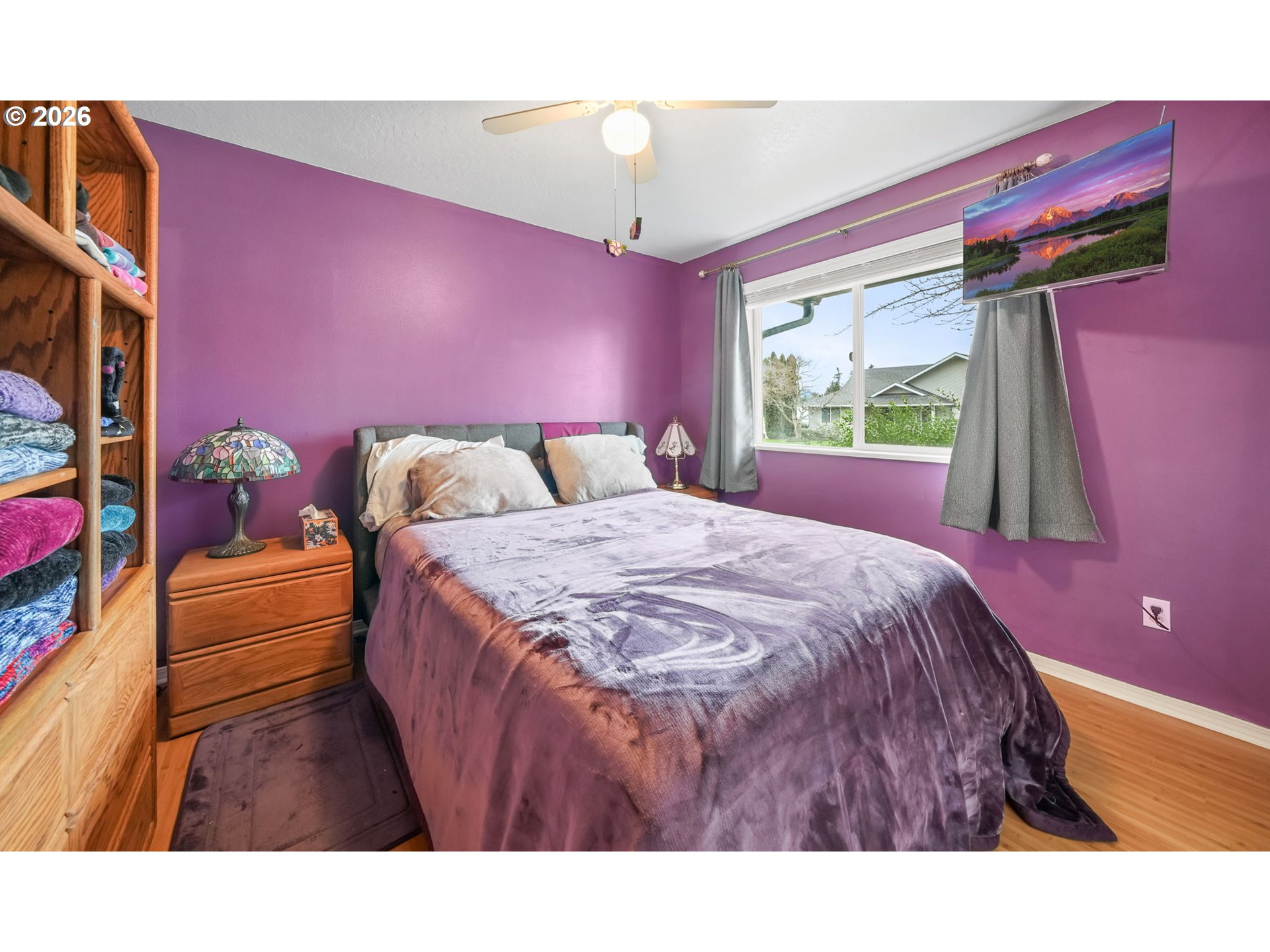 2102 South 8th Street Cottage Grove, OR 97424 - Photo 21 of 28 a spacious bedroom with a bed and a chandelier