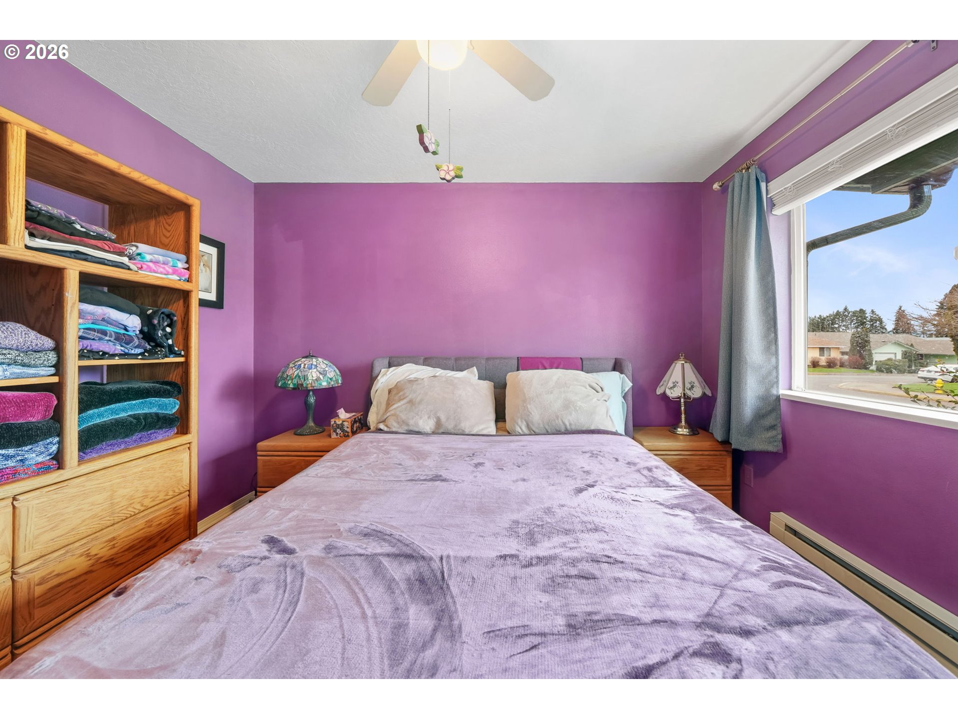 2102 South 8th Street Cottage Grove, OR 97424 - Photo 23 of 28 a bedroom with a bed and a dresser with mirror