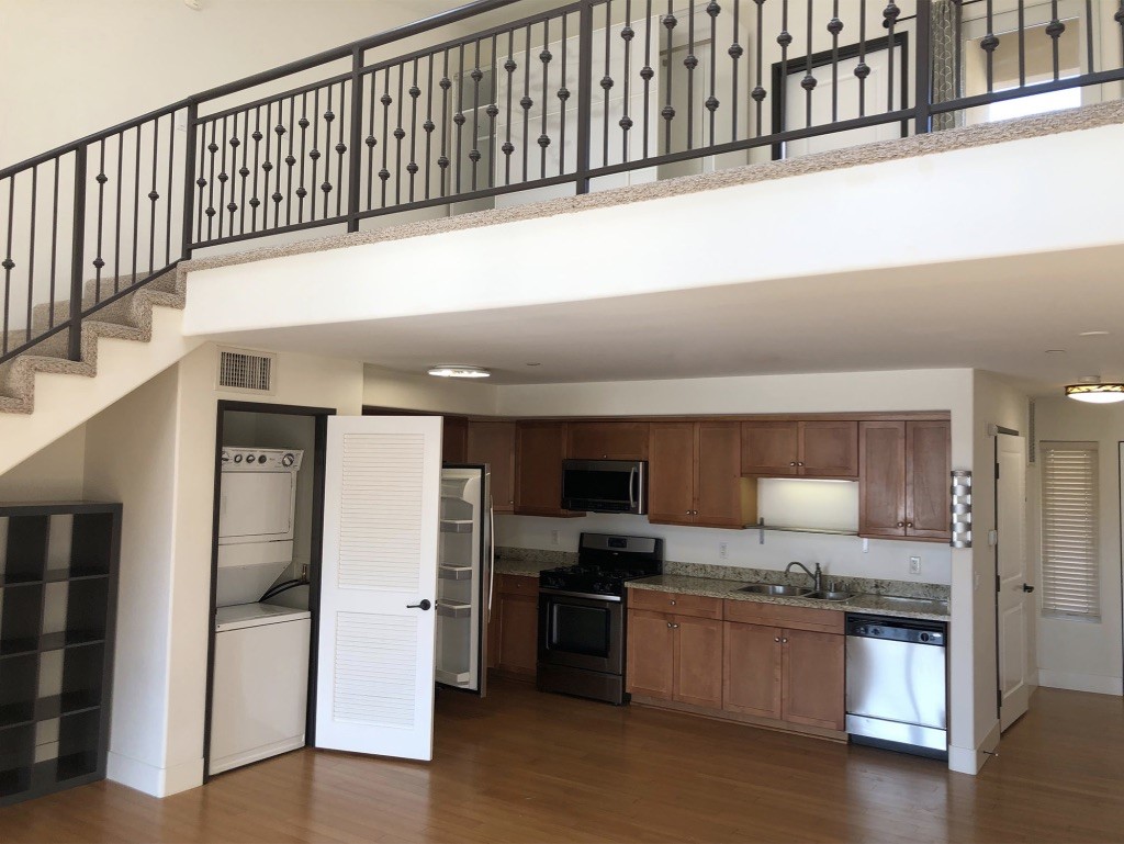 255 West 7th Street, Unit 20 San Pedro, CA 90731 - Photo 3 of 13 a kitchen with stainless steel appliances kitchen island granite countertop a refrigerator and a stove