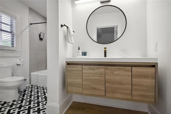 a bathroom with a toilet a sink and a shower