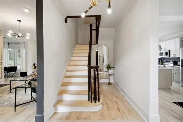 a view of entryway and hall with wooden floor
