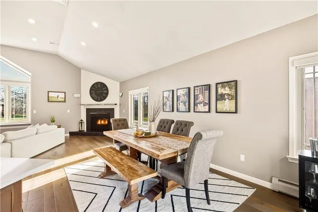 a living room with furniture a fireplace and a window