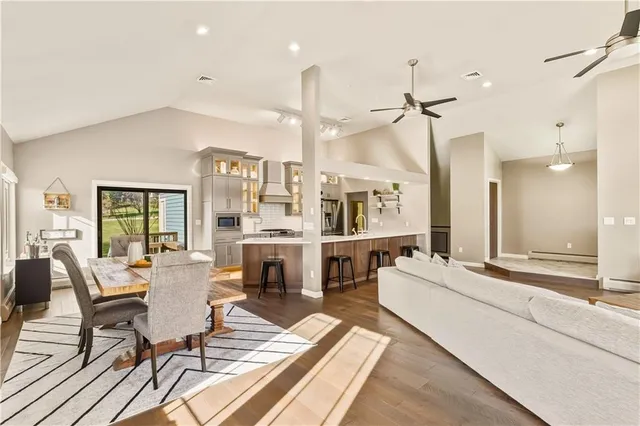 a living room with fireplace furniture and a table
