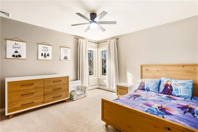 a bedroom with a bed and a couch