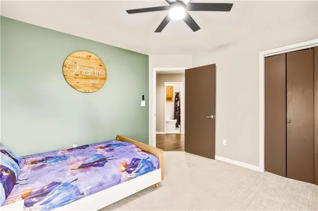 a bedroom with a large bed and a chandelier