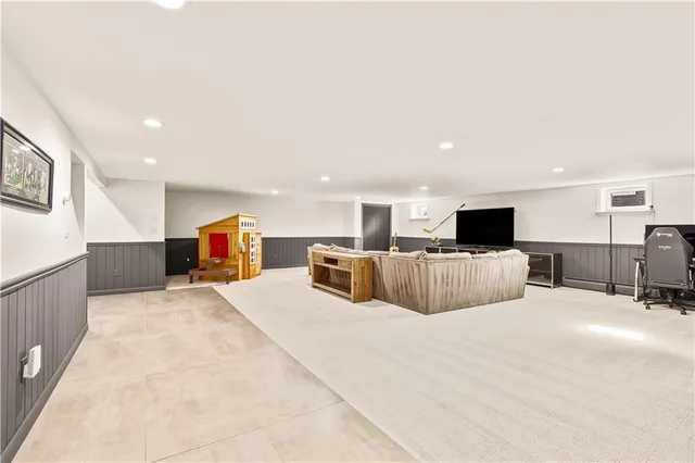 a large bedroom with a bed and a television