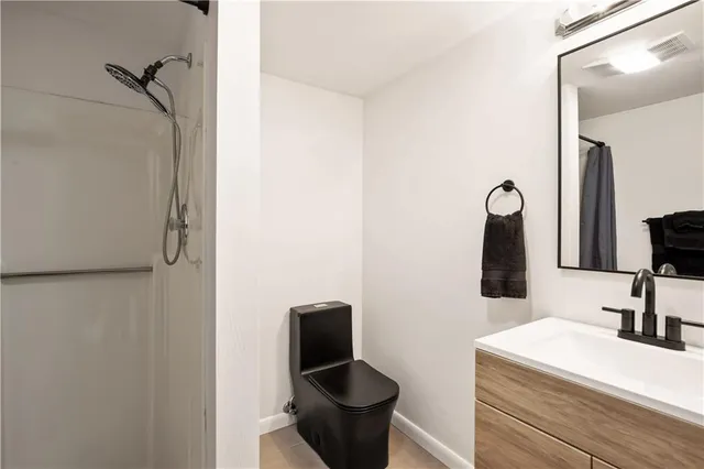 a bathroom with a sink a toilet and a mirror