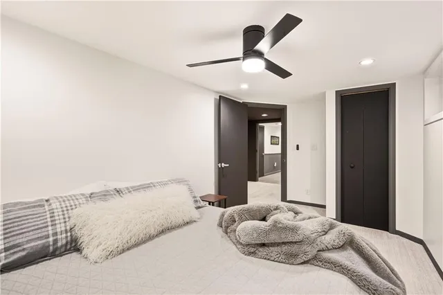 a bedroom with a large bed and a large window