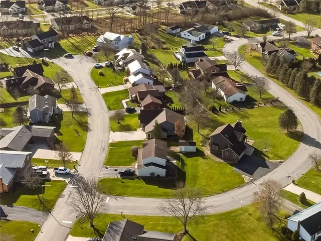 an aerial view of residential houses with outdoor space