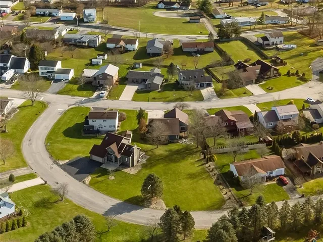 an aerial view of residential houses with outdoor space