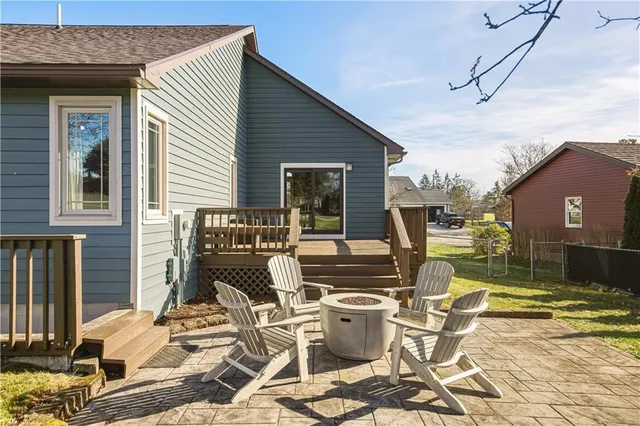 a view of a patio with dining table and chairs with wooden floor