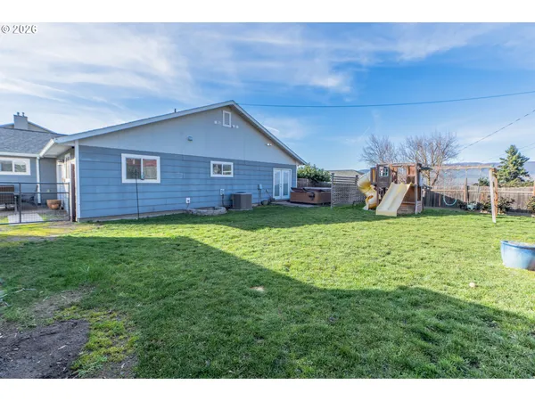 a view of a house with a yard and sitting area