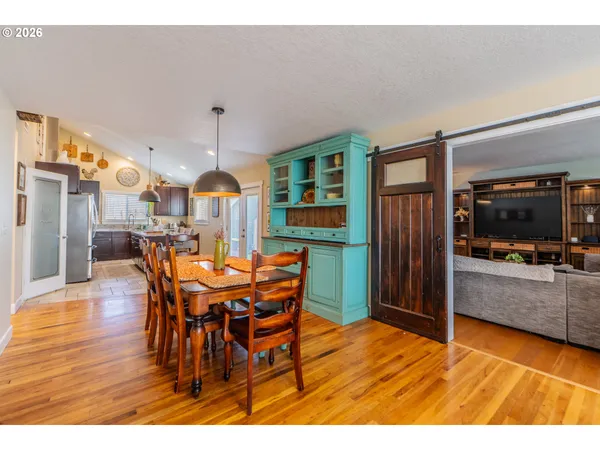 a view of a dining room with furniture and wooden floor