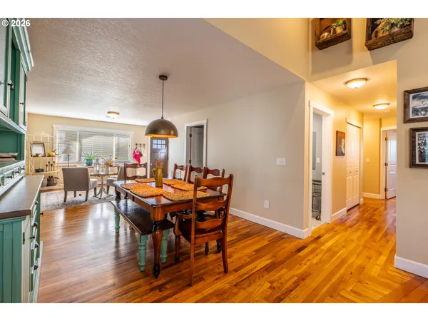 a dining room with furniture and wooden floor