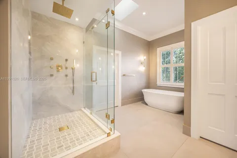 a bathroom with a tub shower and sink