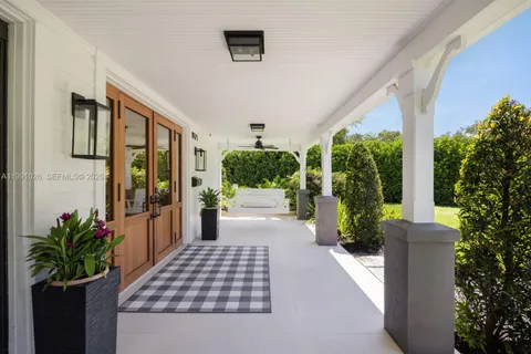 a view of a porch with plants and garden