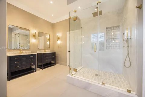 a bathroom with a shower sink and mirror
