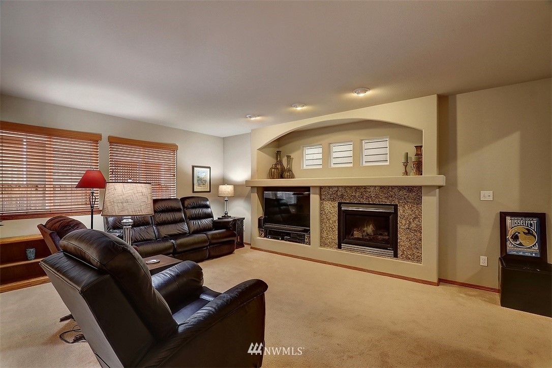 105 196th Place Southwest Bothell, WA 98012 - Photo 2 of 18 a living room with furniture and a fireplace