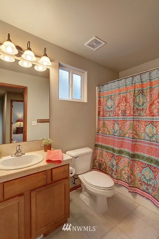 105 196th Place Southwest Bothell, WA 98012 - Photo 13 of 18 a bathroom with a sink a toilet and shower curtain