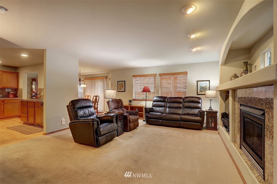 105 196th Place Southwest Bothell, WA 98012 - Photo 3 of 18 a living room with furniture a fireplace and a flat screen tv