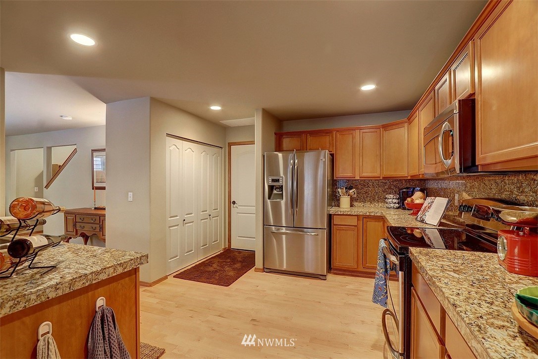 105 196th Place Southwest Bothell, WA 98012 - Photo 6 of 18 a kitchen with stainless steel appliances granite countertop a refrigerator and a stove top oven