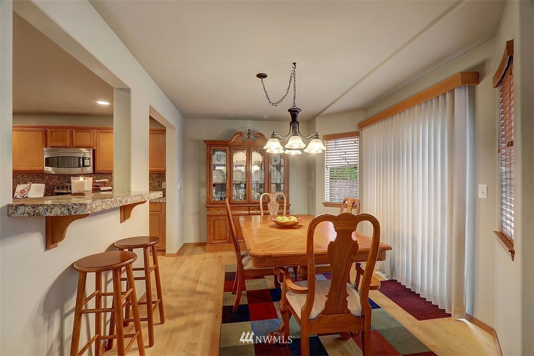 105 196th Place Southwest Bothell, WA 98012 - Photo 7 of 18 a view of a dining room with furniture and chandelier