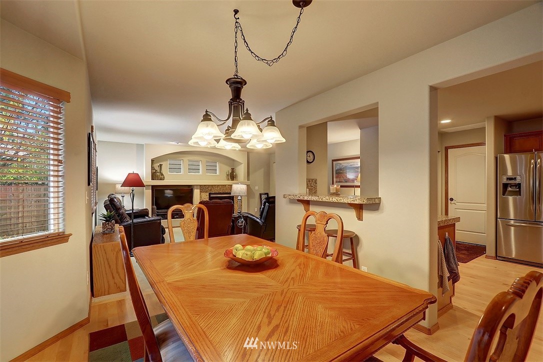 105 196th Place Southwest Bothell, WA 98012 - Photo 8 of 18 a view of a dining room with furniture a chandelier and wooden floor