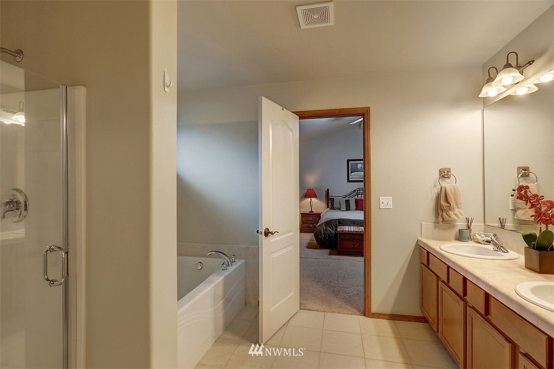 105 196th Place Southwest Bothell, WA 98012 - Photo 10 of 18 a en suite bathroom with a sink a mirror and a shower