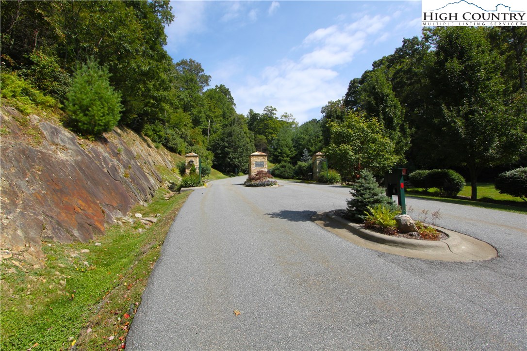 Lot 137 East Indrio Road Blowing Rock, NC 28605 - Photo 23 of 25 a view of a street with a bench and trees