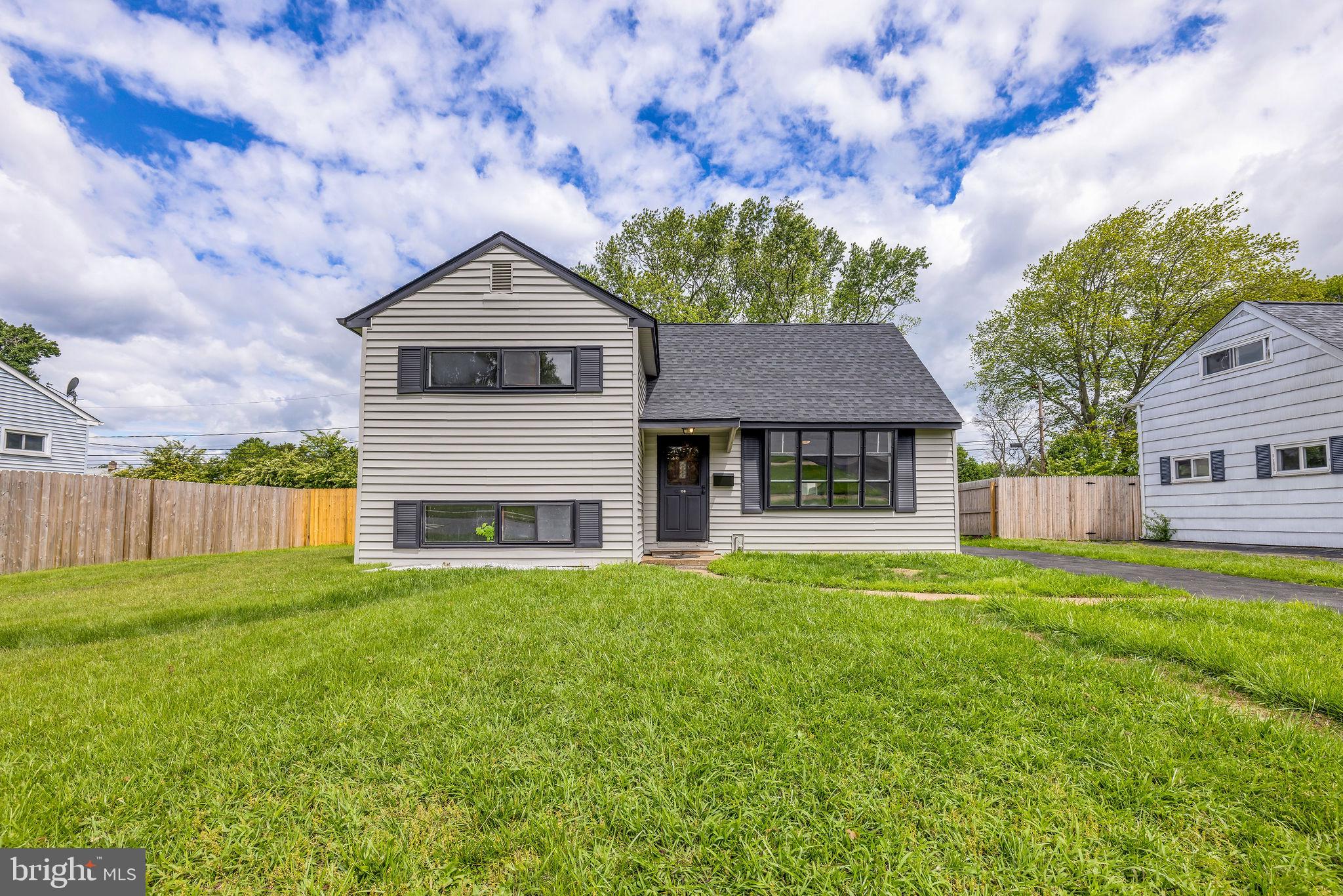a house with lots of trees in the background