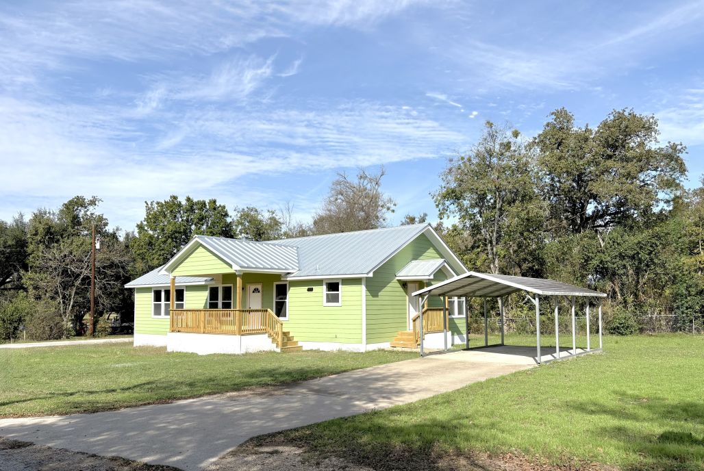 102 Terral Court Cameron, TX 76520 - Photo 2 of 14 a front view of a house with a yard
